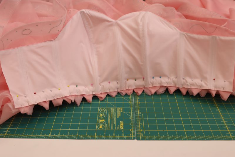 How To Pin Sew Bodice To Skirt - Satin - Mood Fabrics - Glinda Gown Free Sewing Pattern Tutorial - MDF463 - Mood Fabrics Sewciety Blog - Pin and sew bodice to skirt, right sides together.