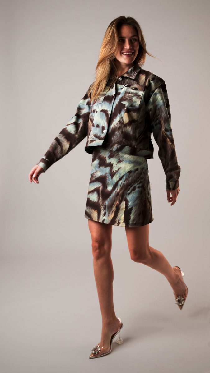 Model in the Cher Jacket and Dion Skirt set, featuring a matching plaid-style printed jacket and mini skirt with a bold retro vibe — Clueless-inspired costume idea.