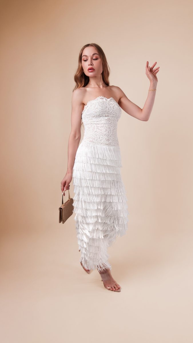 Full-body view of Lumiere Strapless Dress styled for a Jazz Age-inspired outfit, highlighting its lace bodice, fringe layers, and elegant vintage glamour.