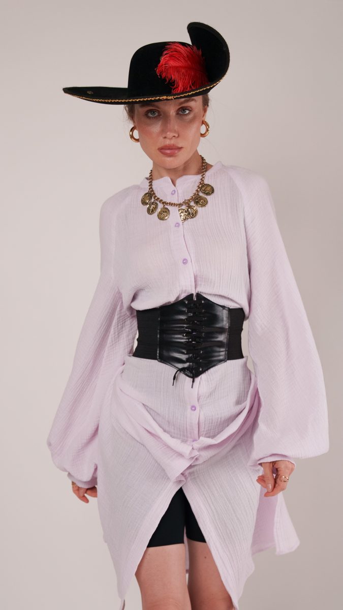 Close-up of the pirate costume highlighting the gold coin necklace, hoop earrings, dramatic puff sleeves, and feathered tricorn hat.