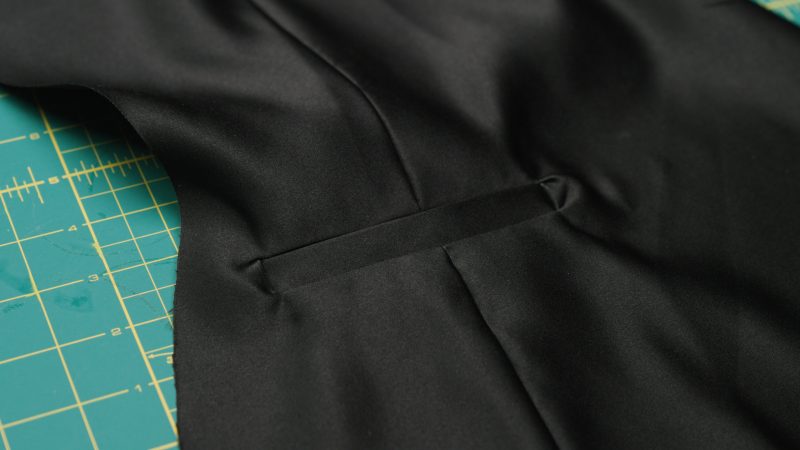 How To Flip Welts Inside Out - - Mood Fabrics - Nolita Vest and Skirt Set Free Sewing Pattern Tutorial - MDF466 MDF467 - Mood Fabrics Sewciety Blog - Flip the welts and pocket bag towards the inside of the vest front.