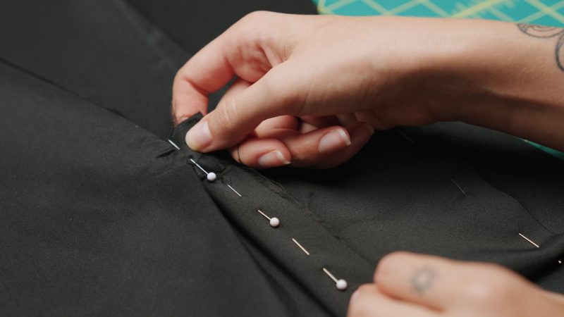 How To Pin Sew Pocket Bag Side Seams - - Mood Fabrics - Nolita Vest and Skirt Set Free Sewing Pattern Tutorial - MDF466 MDF467 - Mood Fabrics Sewciety Blog - Pin and sew the sides of the pocket bag shut, ensuring that the pocket bag, pocket welts, and triangular cutouts from the pocket opening are all caught in the seam.
