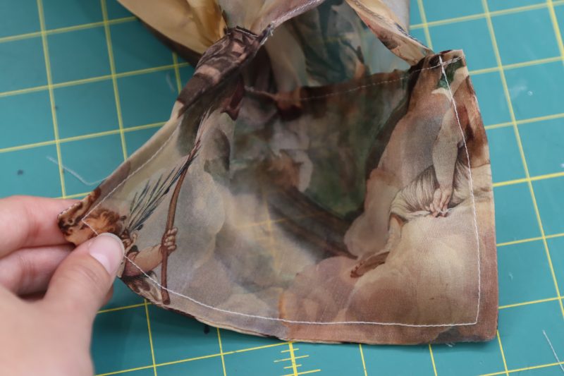 How To Sandwich Gathered Sleeve Into Cuff - Silk Organza - Mood Fabrics - Firenze Blouse Trousers Free Sewing Pattern Tutorial - MDF464 - Mood Fabrics Sewciety Blog - Sandwich the open seam on the top of the cuff around the gathered edge of each sleeve.