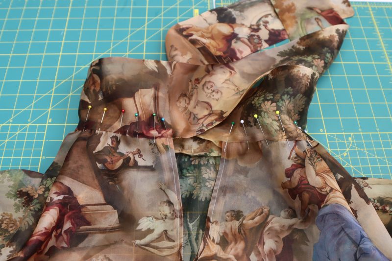 How To Pin Sew Neck Tie To Neckline - Silk Organza - Mood Fabrics - Firenze Blouse Trousers Free Sewing Pattern Tutorial - MDF464 - Mood Fabrics Sewciety Blog - Pin and sew the opening in the neck tie to the gathered edge of the neckline.