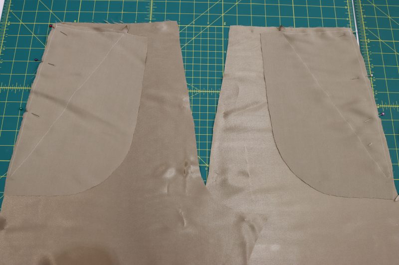 How To Pin Sew Front Pocket Bag To Side Seam - Satin - Mood Fabrics - Firenze Blouse Trousers Free Sewing Pattern Tutorial - MDF464 - Mood Fabrics Sewciety Blog - Pin and sew the back pocket bags to the back side seams, right sides together.