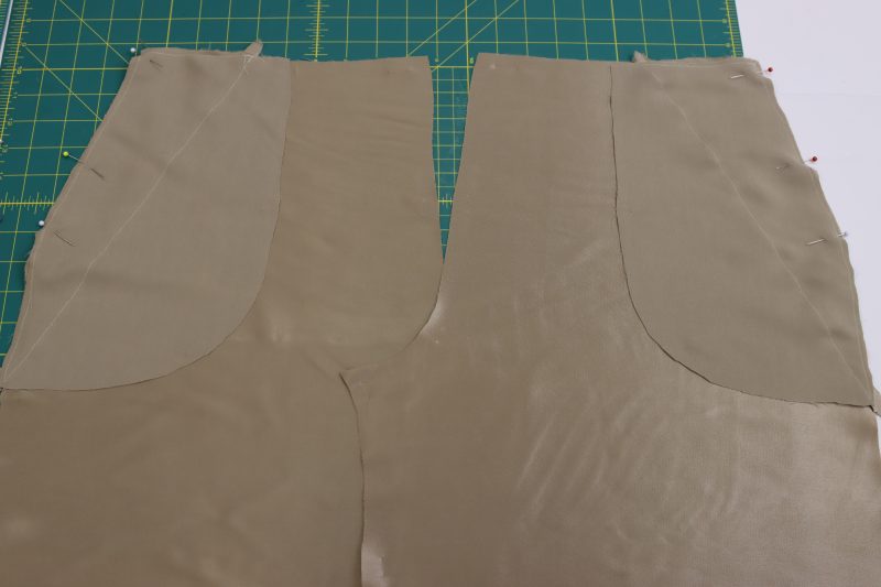 How To Pin Sew Back Pocket Bag To Side Seam - Satin - Mood Fabrics - Firenze Blouse Trousers Free Sewing Pattern Tutorial - MDF464 - Mood Fabrics Sewciety Blog - Pin and sew the front pocket bags to the front side seams, right sides together.