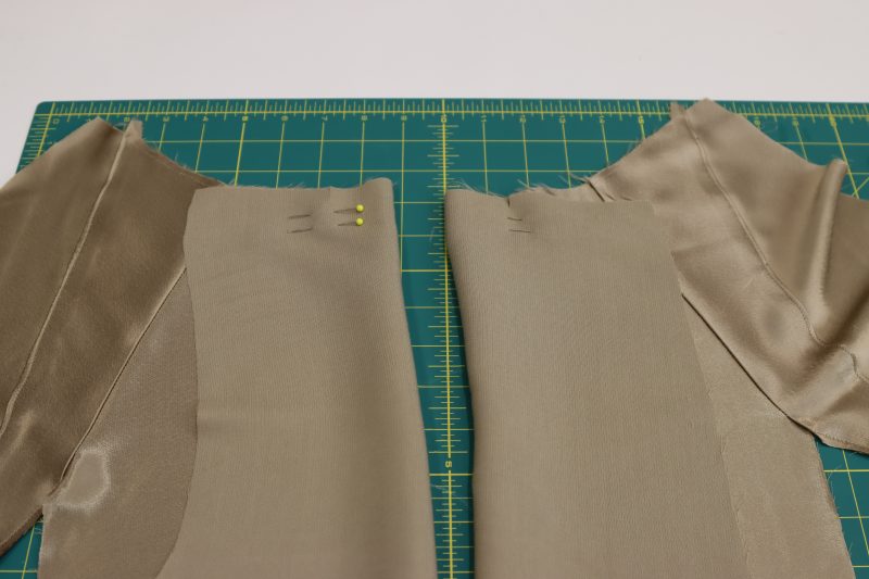 How To Pin Sew Pleats - Satin - Mood Fabrics - Firenze Blouse Trousers Free Sewing Pattern Tutorial - MDF464 - Mood Fabrics Sewciety Blog - Pin and sew a 1 inch stitch over the front notches to create the front pleats.