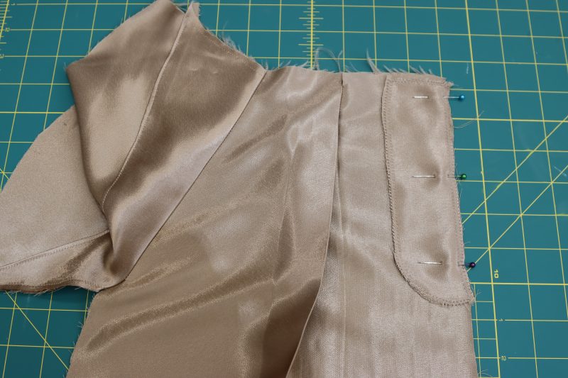 How To Pin Sew Fly Facing - Satin - Mood Fabrics - Firenze Blouse Trousers Free Sewing Pattern Tutorial - MDF464 - Mood Fabrics Sewciety Blog - Pin and sew the fly facing to the wearer’s right side of the pants.