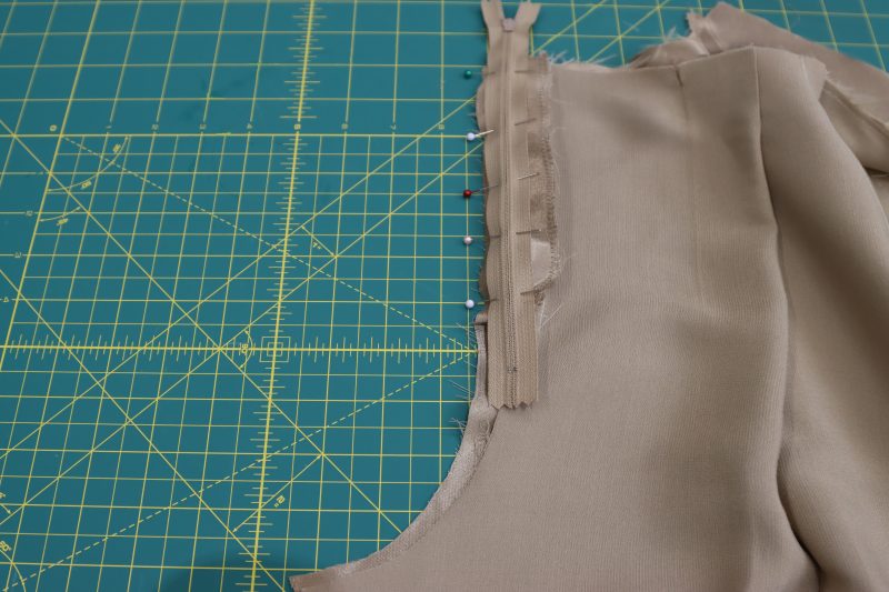 How To Pin Sew Zipper To Front Left Side - Regular Zipper - Mood Fabrics - Firenze Blouse Trousers Free Sewing Pattern Tutorial - MDF464 - Mood Fabrics Sewciety Blog - Pin and sew the zipper to the wearer’s left side of the pants, right sides together.