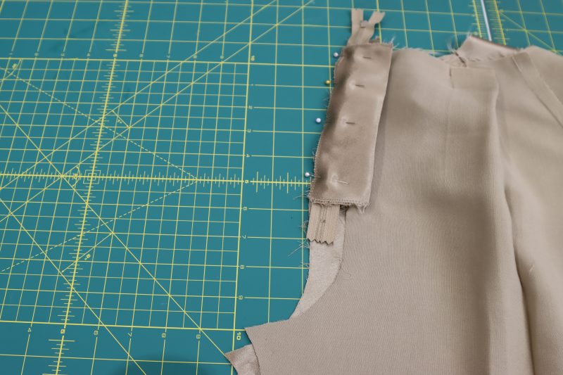 How To Pin Sew Fly Shield - Satin - Mood Fabrics - Firenze Blouse Trousers Free Sewing Pattern Tutorial - MDF464 - Mood Fabrics Sewciety Blog - Pin and sew the fly shield to the wearer’s left side of the pants.