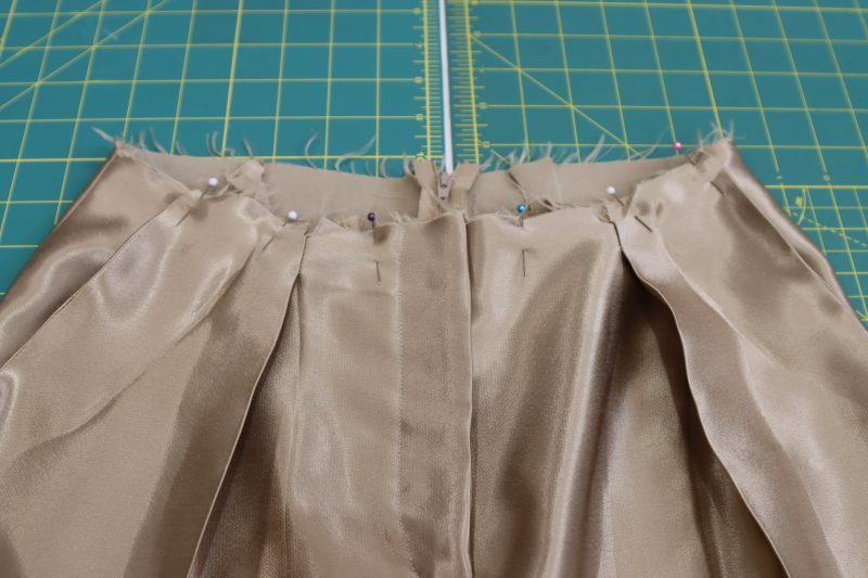 How To Stay Stitch Pockets To Waistline - Satin - Mood Fabrics - Firenze Blouse Trousers Free Sewing Pattern Tutorial - MDF464 - Mood Fabrics Sewciety Blog - Stay stitch the tops of the pocket bags and the front please to the waist opening.