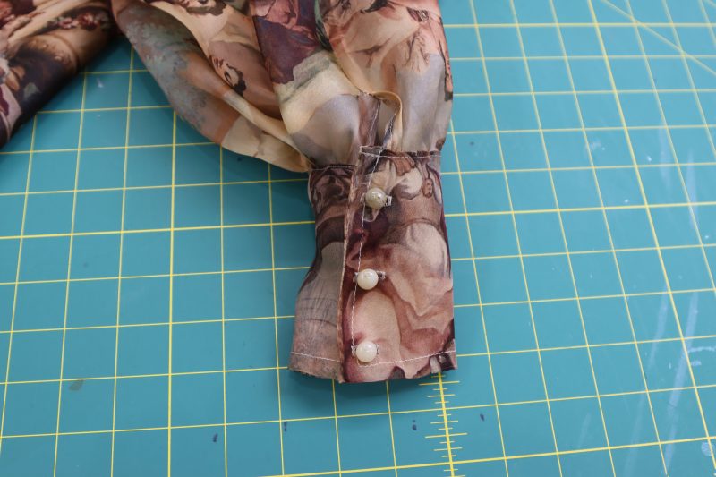 How To Sew Buttonholes And Buttons - Shank Button - Mood Fabrics - Firenze Blouse Trousers Free Sewing Pattern Tutorial - MDF464 - Mood Fabrics Sewciety Blog - Sew buttonholes and buttons equally spaced on sleeve cuffs.