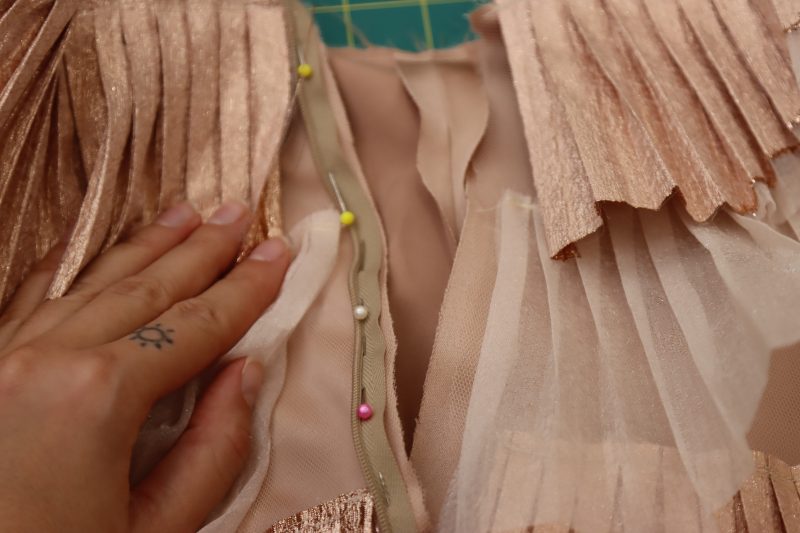 How To Pin Sew Invisible Zipper Right Side - Invisible Zipper - Mood Fabrics - Nolita Vest and Skirt Set Free Sewing Pattern Tutorial - MDF466 MDF467 - Mood Fabrics Sewciety Blog - Pin and sew one side of the invisible zipper to one side of the side seam opening.