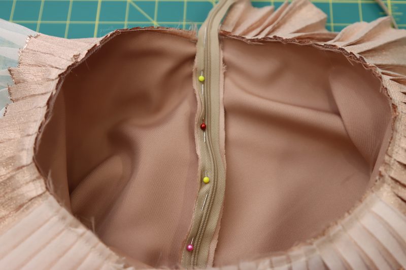 How To Pin Sew Invisible Zipper Left Side - Invisible Zipper - Mood Fabrics - Nolita Vest and Skirt Set Free Sewing Pattern Tutorial - MDF466 MDF467 - Mood Fabrics Sewciety Blog - Pin and sew the other side of the zipper tape to the other side of the side seam opening.