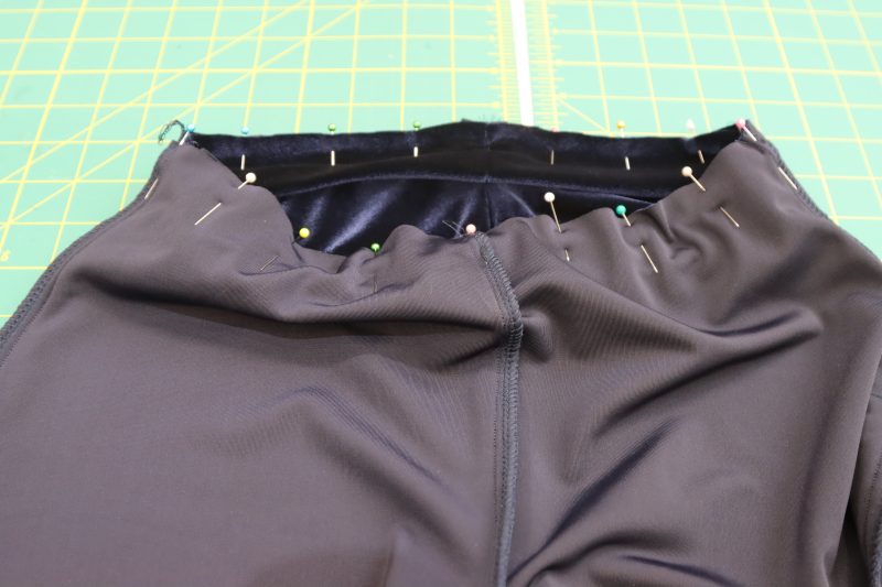 How To Pin Sew Waistband To Waistline - Stretch Velour - Mood Fabrics - Tarrytown Tracksuit Free Sewing Pattern Tutorial - MDF471 - Mood Fabrics Sewciety Blog - Pin and sew the waistband to the waistline of the pants, right sides together.