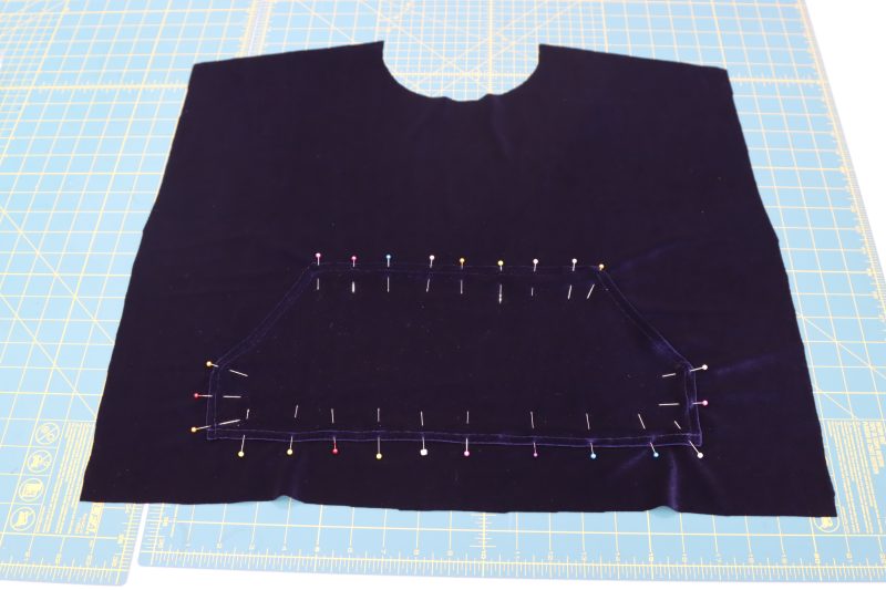 How To Pin Sew Pocket Pouch To Front - Stretch Velour - Mood Fabrics - Tarrytown Tracksuit Free Sewing Pattern Tutorial - MDF471 - Mood Fabrics Sewciety Blog - Pin and sew the pocket pouch to the front of the tracksuit top, leaving gaps on the diagonal sides so that the pocket is functional.