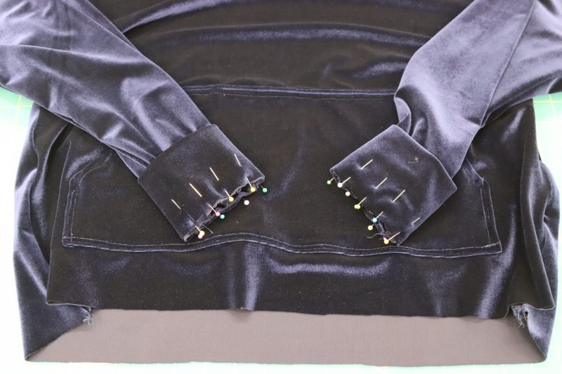 How To Pin Sew Cuffs To Sleeves - Stretch Velour - Mood Fabrics - Tarrytown Tracksuit Free Sewing Pattern Tutorial - MDF471 - Mood Fabrics Sewciety Blog - Pin and sew the cuffs to the ends of the sleeves.