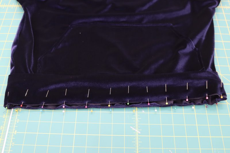 How To Pin Sew Shirt Waistband - Stretch Velour - Mood Fabrics - Tarrytown Tracksuit Free Sewing Pattern Tutorial - MDF471 - Mood Fabrics Sewciety Blog - Pin and sew the waistband to the hem of the top.