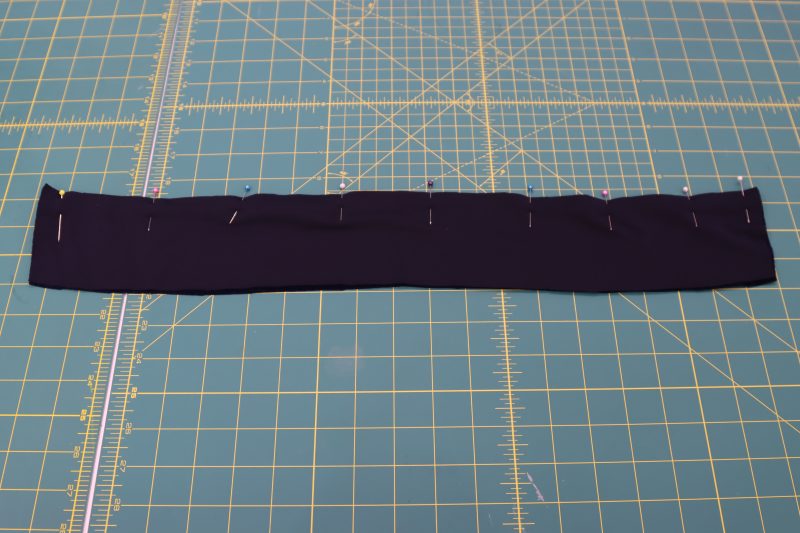 How To Pin Sew Collar Right Sides Together - Stretch Velour - Mood Fabrics - Tarrytown Tracksuit Free Sewing Pattern Tutorial - MDF471 - Mood Fabrics Sewciety Blog - Pin and sew one of the long sides of the collar.