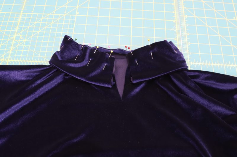 How To Pin Sew Collar To Neckline - Stretch Velour - Mood Fabrics - Tarrytown Tracksuit Free Sewing Pattern Tutorial - MDF471 - Mood Fabrics Sewciety Blog - Pin and sew the raw edge of the collar to the neckline of the top.