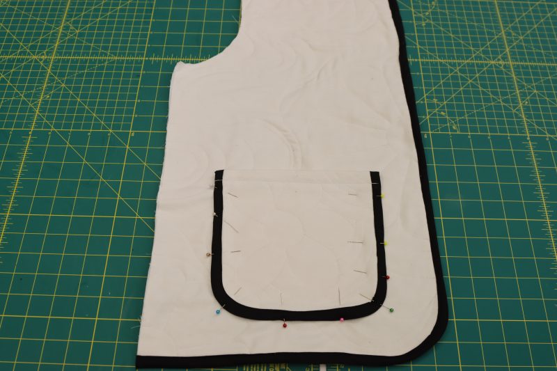 How To Sew Bias Binding To Coat Front - Mercerized Organic Egyptian Cotton Voile - Mood Fabrics - Coeur D'Alene Coat Free Sewing Pattern Tutorial - MDF472 - Mood Fabrics Sewciety Blog - Sew the bias binding to the bottom edge and front opening of the coat front pieces.