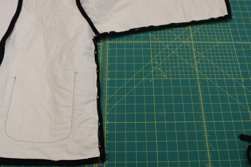 How To Attach Bias Binding To Sleeves - Mercerized Organic Egyptian Cotton Voile - Mood Fabrics - Coeur D'Alene Coat Free Sewing Pattern Tutorial - MDF472 - Mood Fabrics Sewciety Blog - Attach bias binding to the seam allowance of the sleeve and side seams.