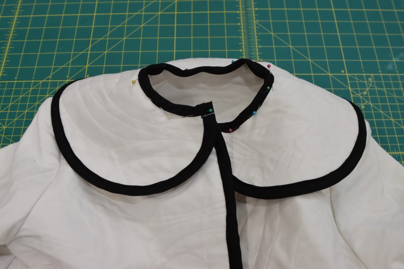 How To Sew Bias Binding To Seam Allowance - Mercerized Organic Egyptian Cotton Voile - Mood Fabrics - Coeur D'Alene Coat Free Sewing Pattern Tutorial - MDF472 - Mood Fabrics Sewciety Blog - Sew the bias binding to the seam allowance of the fabric between the collar and the coat.