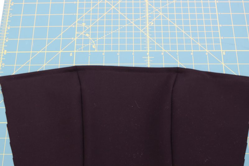 How To Hem Top Front Edge - Stretch Ponte Knit - Mood Fabrics - Ketchum Jumpsuit Free Sewing Pattern Tutorial - MDF473 - Mood Fabrics Sewciety Blog - Hem the top edge of the top front piece.