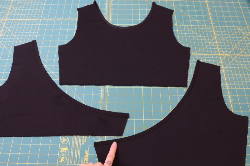 How To Hem Front Back Necklines - Performance Spandex - Mood Fabrics - Adagio Wrap Cardigan Free Sewing Pattern Tutorial - MDF478 - Mood Fabrics Sewciety Blog - Hem the front and back necklines of the top.