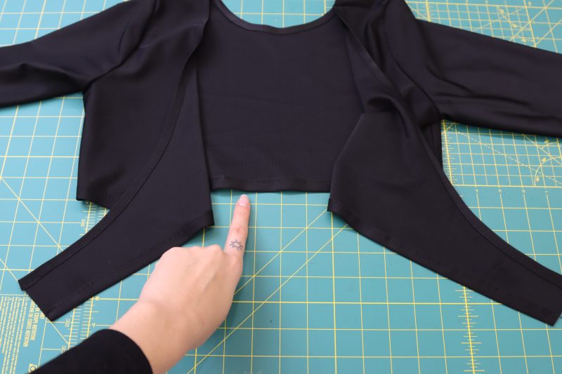 How To Hem Bottom Of Wrap Top - Performance Spandex - Mood Fabrics - Adagio Wrap Cardigan Free Sewing Pattern Tutorial - MDF478 - Mood Fabrics Sewciety Blog - Hem the bottom of the wrap top.