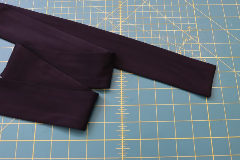 How To Flip Wrap Ties - Performance Spandex - Mood Fabrics - Adagio Wrap Cardigan Free Sewing Pattern Tutorial - MDF478 - Mood Fabrics Sewciety Blog - Flip the ties right sides out.