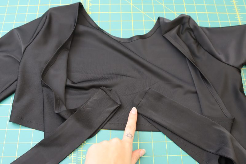 How To Sew Ties To Top Front - Performance Spandex - Mood Fabrics - Adagio Wrap Cardigan Free Sewing Pattern Tutorial - MDF478 - Mood Fabrics Sewciety Blog - Sew the raw edges of the wrap ties to the raw edges of the front of the top.