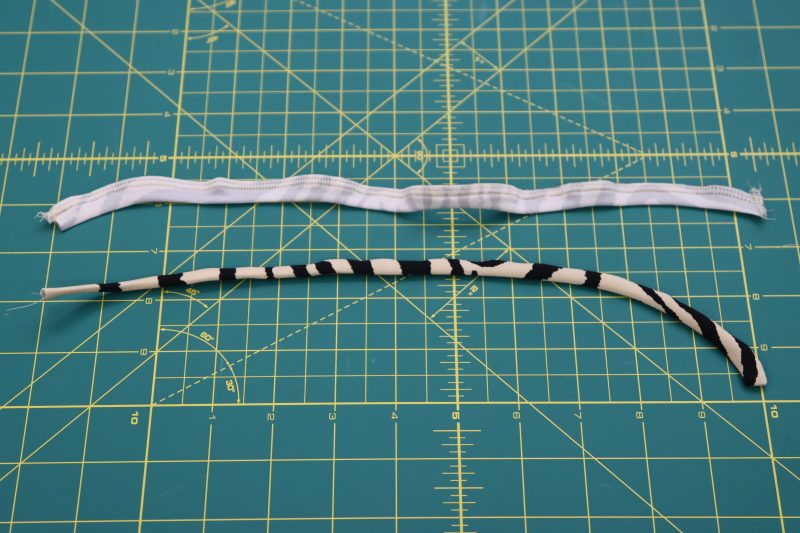 How To Flip Ties Right Sides Out - Interlock Knit - Mood Fabrics - Soho Maxi Slip Dress Free Sewing Pattern Tutorial - MDF474 - Mood Fabrics Sewciety Blog - Flip the serged ties right sides out with a tube turner.