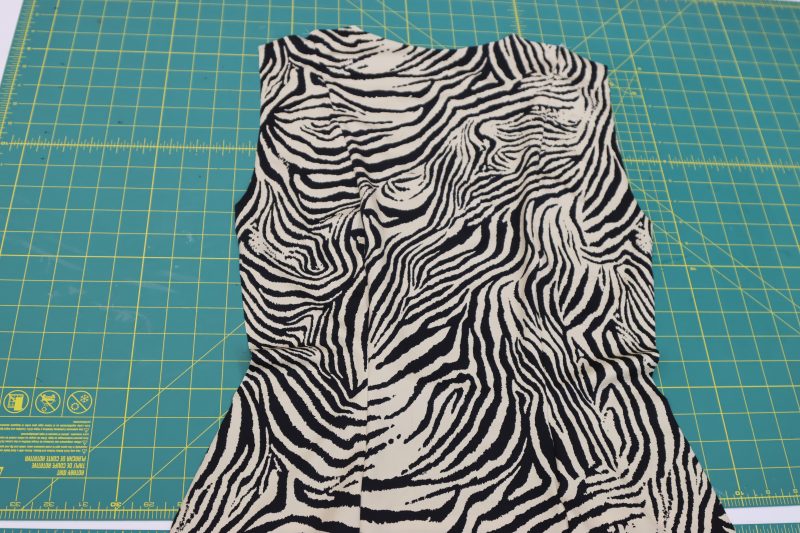 How To Serge Back Side Pieces - Interlock Knit - Mood Fabrics - Soho Maxi Slip Dress Free Sewing Pattern Tutorial - MDF474 - Mood Fabrics Sewciety Blog - Serge the curved edges of the back side pieces to the back center piece.