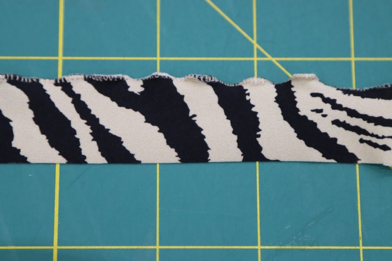 How To Sew Zigzag Over Neckline Ruffle - Interlock Knit - Mood Fabrics - Soho Maxi Slip Dress Free Sewing Pattern Tutorial - MDF474 - Mood Fabrics Sewciety Blog - Sew the zigzag stitch over the stretched edge of the neckline ruffle.