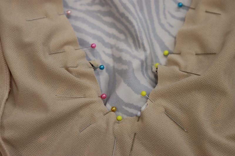 How To Pin Neckline Ties - Interlock Knit - Mood Fabrics - Soho Maxi Slip Dress Free Sewing Pattern Tutorial - MDF474 - Mood Fabrics Sewciety Blog - Pin the ties in place at the pointed corners or the plunge neckline.