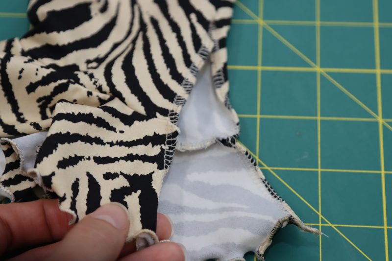 How To Serge Sleeve Slit - Gutermann Sew All Thread - Mood Fabrics - Soho Maxi Slip Dress Free Sewing Pattern Tutorial - MDF474 - Mood Fabrics Sewciety Blog - Serge the raw edge of the slit opening at the wrist.