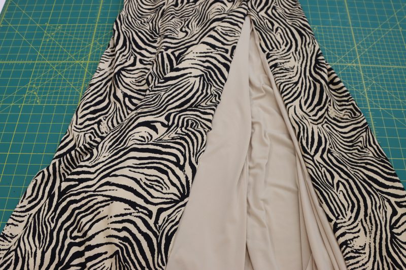 How To Pin Main Fabric Lining Slit Closed - Interlock Knit - Mood Fabrics - Soho Maxi Slip Dress Free Sewing Pattern Tutorial - MDF474 - Mood Fabrics Sewciety Blog - Pin the lining dress and the main fabric dress right sides together along both sides of the slit.