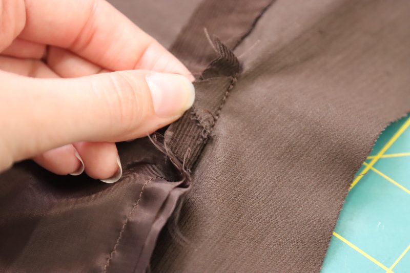 How To Sew Welt Pocket Sides - Featherwale Cotton Corduroy - Mood Fabrics - Fawn Mini Dress Free Sewing Pattern Tutorial - MDF476 - Mood Fabrics Sewciety Blog - Sew the sides of the welt pocket opening shut.