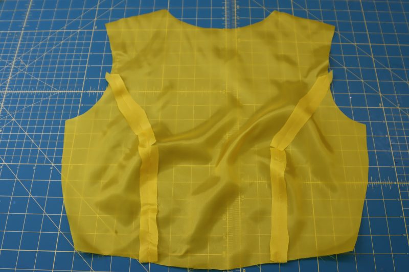 How To Pin Sew Top Front Linings - Bemberg Lining - Mood Fabrics - Silverstone Mini Dress Free Sewing Pattern Tutorial - MDF489 - Mood Fabrics Sewciety Blog - Pin and sew the top front side lining pieces to the top front center lining piece.