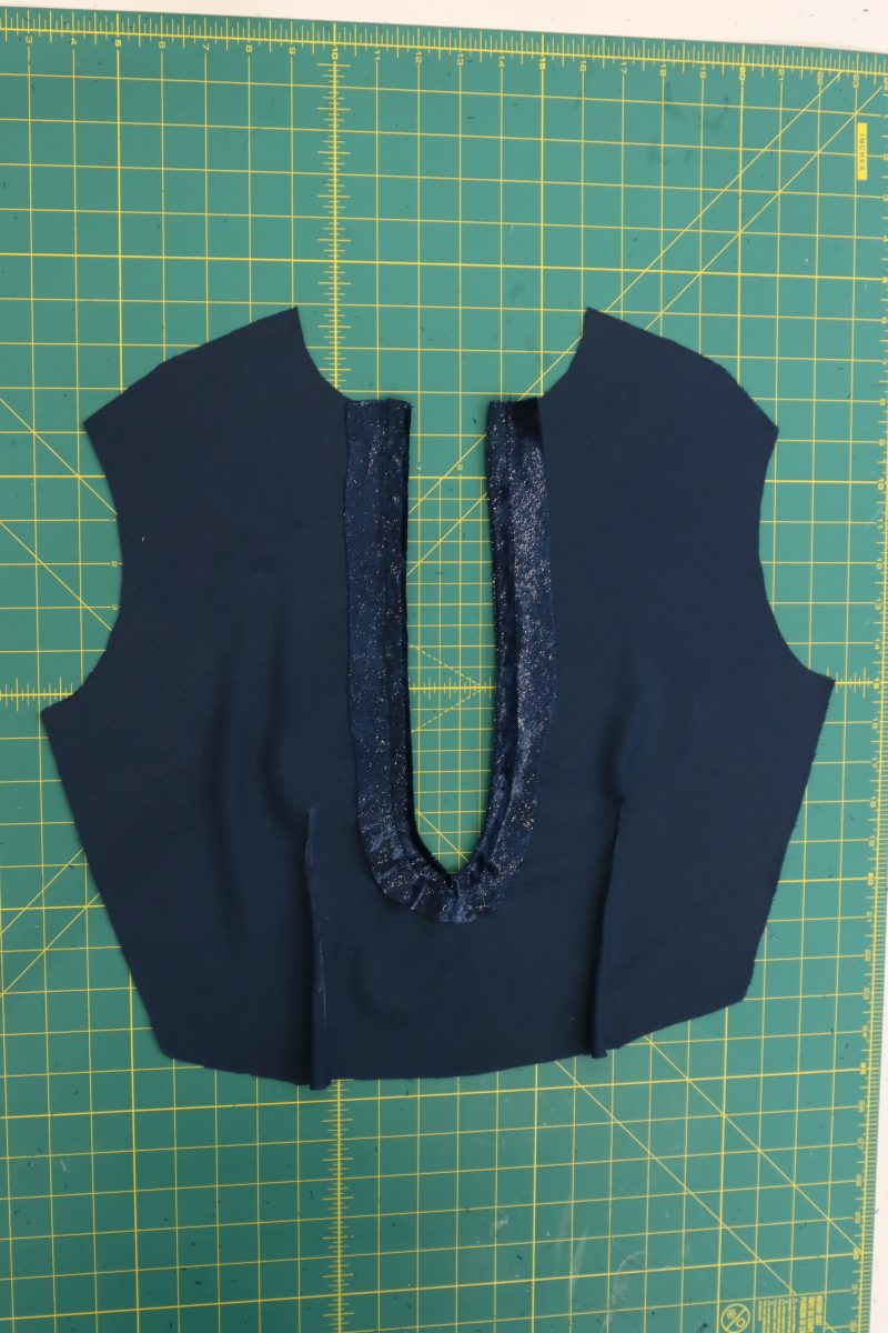 How To Flip Keyhole Facing - Metallic Velvet - Mood Fabrics - Jasper Jumpsuit Free Sewing Pattern Tutorial - MDF486 - Mood Fabrics Sewciety Blog - Flip the keyhole facing to the wrong side of the top front then topstitch them together.