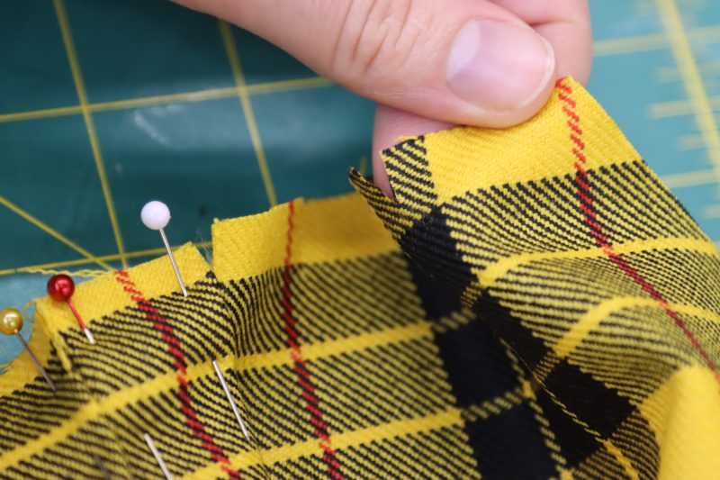 How To Fold Third Pleat - Virgin Wool Twill - Mood Fabrics - Silverstone Mini Dress Free Sewing Pattern Tutorial - MDF489 - Mood Fabrics Sewciety Blog - Fold the third pleat in the opposite direction as the first two.