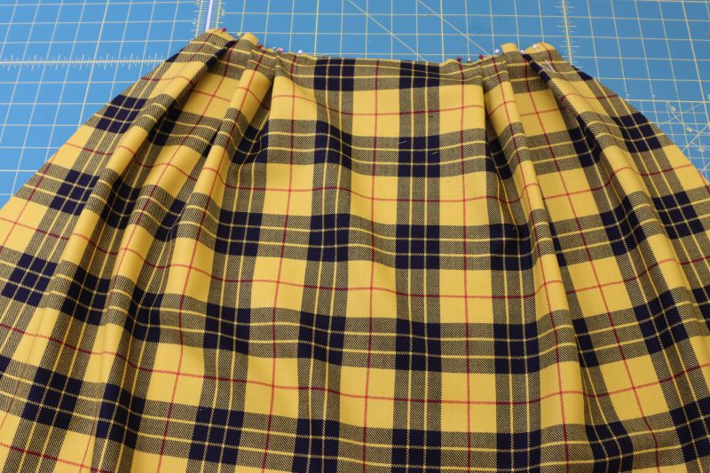 How To Pin Both Sides Pleats - Virgin Wool Twill - Mood Fabrics - Silverstone Mini Dress Free Sewing Pattern Tutorial - MDF489 - Mood Fabrics Sewciety Blog - Pin the pleats on both sides of the skirt.