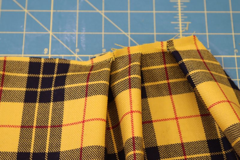 How To Topstitch Pleats - Virgin Wool Twill - Mood Fabrics - Silverstone Mini Dress Free Sewing Pattern Tutorial - MDF489 - Mood Fabrics Sewciety Blog - Topstitch over the pleats to keep them in place.