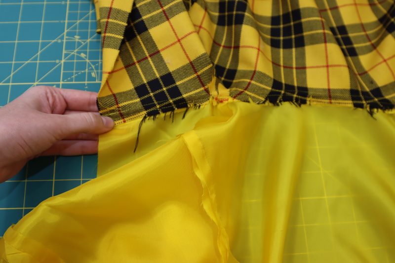 How To Press Seam Allowance Towards Lining - Bemberg Lining - Mood Fabrics - Silverstone Mini Dress Free Sewing Pattern Tutorial - MDF489 - Mood Fabrics Sewciety Blog - Press the seam allowance towards the lining at the neckline.