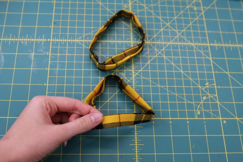 How To Fold Closed Sleeve Cuffs - Virgin Wool Twill - Mood Fabrics - Silverstone Mini Dress Free Sewing Pattern Tutorial - MDF489 - Mood Fabrics Sewciety Blog - Fold the sleeve cuffs back into their shape.