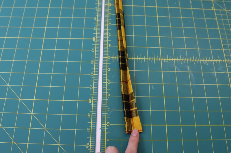 How To Fold Sleeve Cuff - Virgin Wool Twill - Mood Fabrics - Silverstone Mini Dress Free Sewing Pattern Tutorial - MDF489 - Mood Fabrics Sewciety Blog - Fold and press the sleeve cuff into a long skinny strip that is folded into quarters.