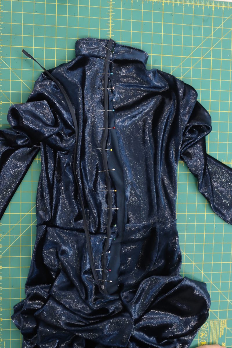 How To Pin Zipper Tape Face Down - Invisible Zipper - Mood Fabrics - Jasper Jumpsuit Free Sewing Pattern Tutorial - MDF486 - Mood Fabrics Sewciety Blog - Pin the zipper tape, open the zipper, and sew the right hand side of the zipper to the left hand side of the center back seam.