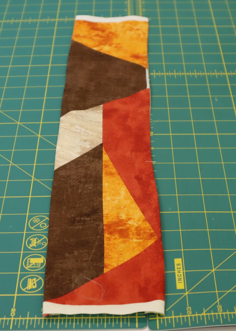 How To Press Strap Fabric to Lining - Printed Quilting Cotton - Mood Fabrics - Pecan Patchwork Bag Free Sewing Pattern Tutorial - MDF482 - Mood Fabrics Sewciety Blog - Strap sewn and pressed result!