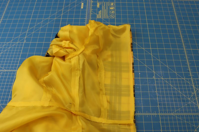 How To Flip Dres Wrong Sides Out - Bemberg Lining - Mood Fabrics - Silverstone Mini Dress Free Sewing Pattern Tutorial - MDF489 - Mood Fabrics Sewciety Blog - Flip the dress so that the wrong sides of both the lining and the main fabric are facing outwards.